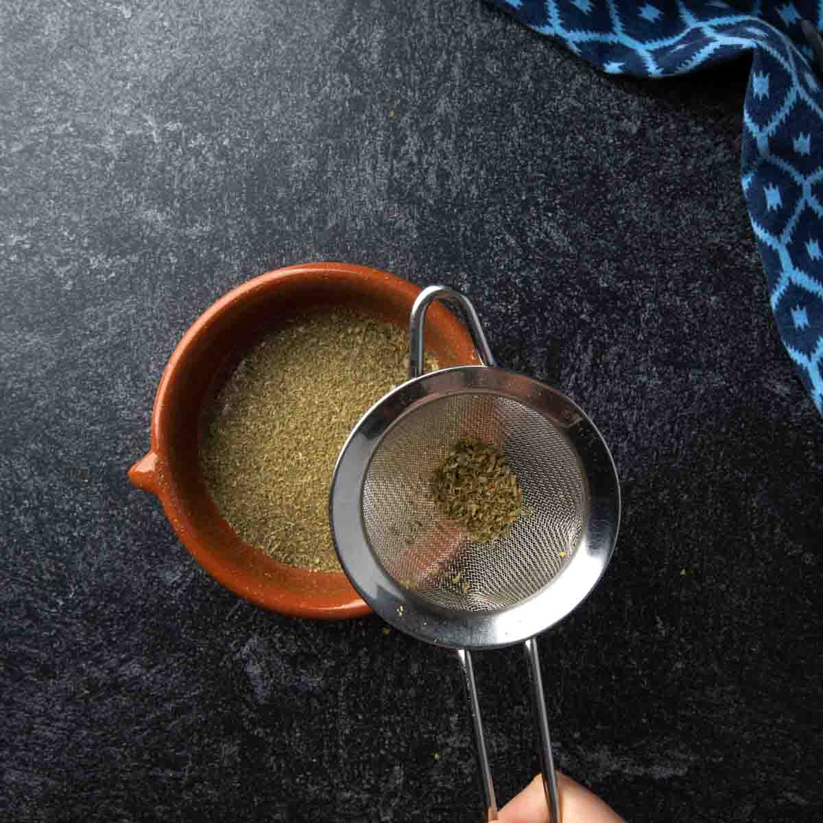 Sifted dried mint and oregano through a fine mesh strainer.
