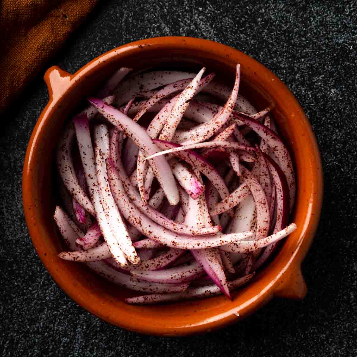 A dish of sliced sumac onions. 