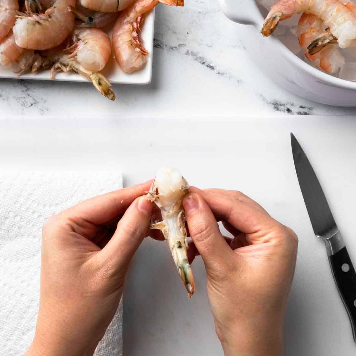 Peeling away the shrimp skin.