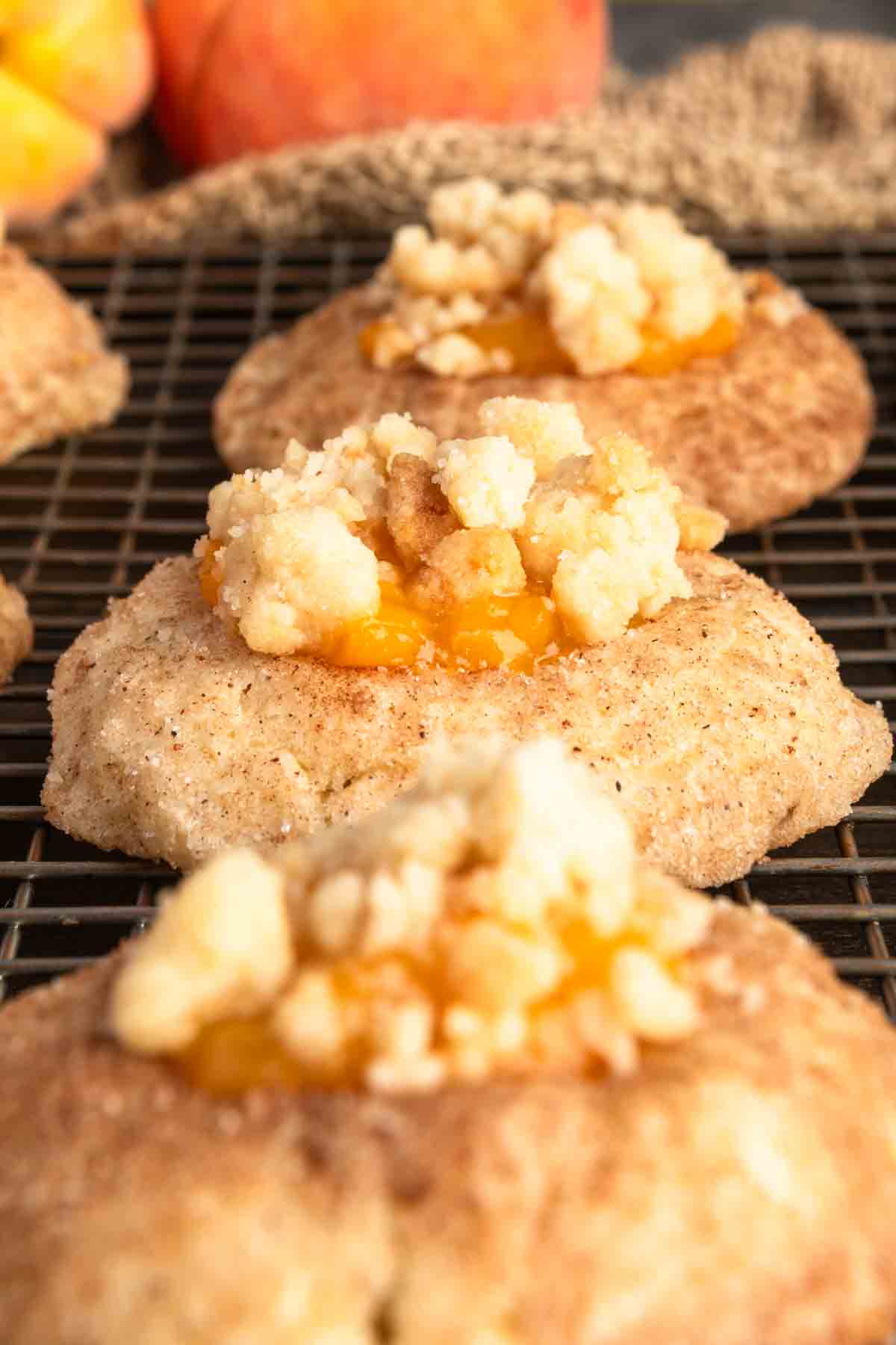 A row of peach cobbler cookies on a cooling rack. 