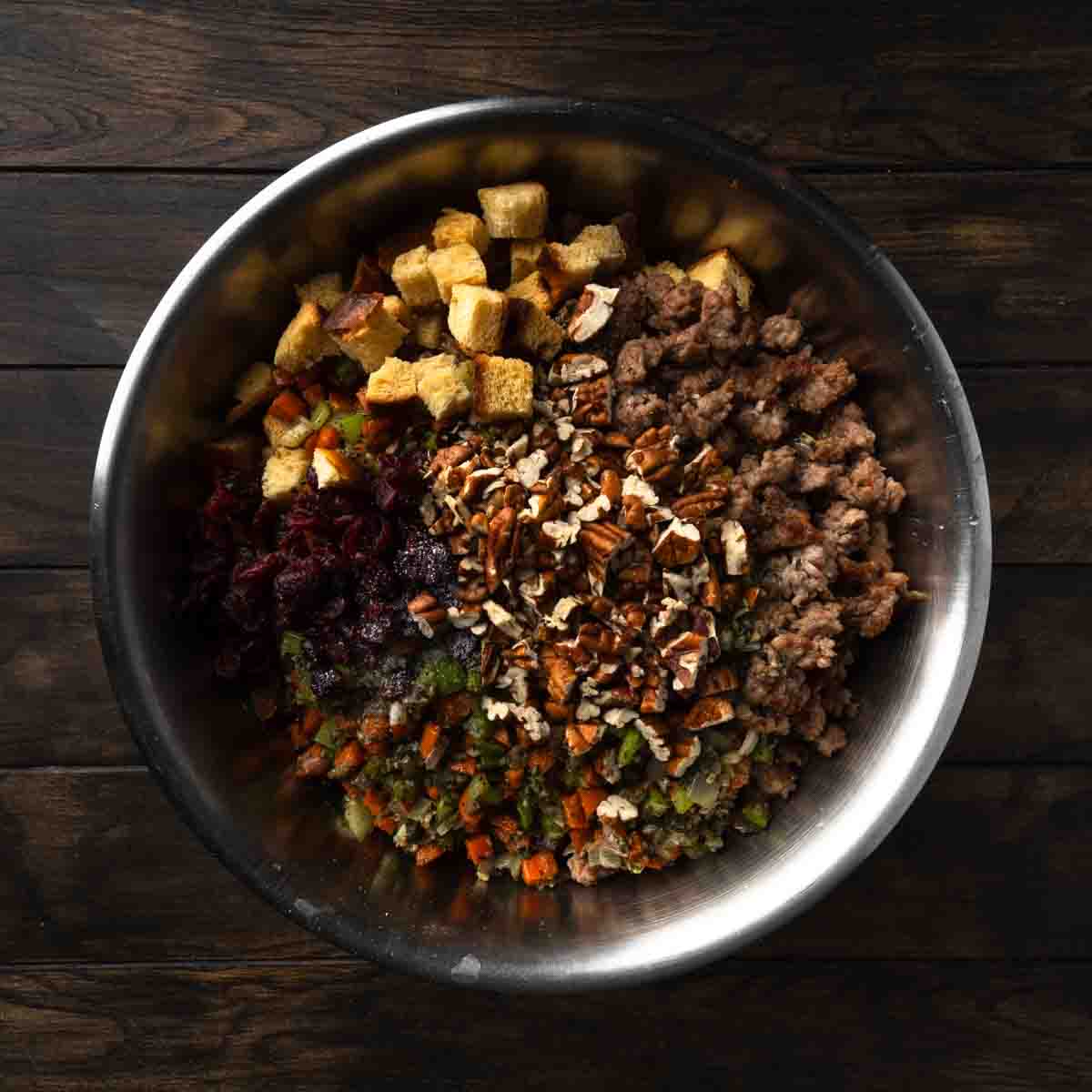 A big bowl full of dried challah and stuffing ingredients.