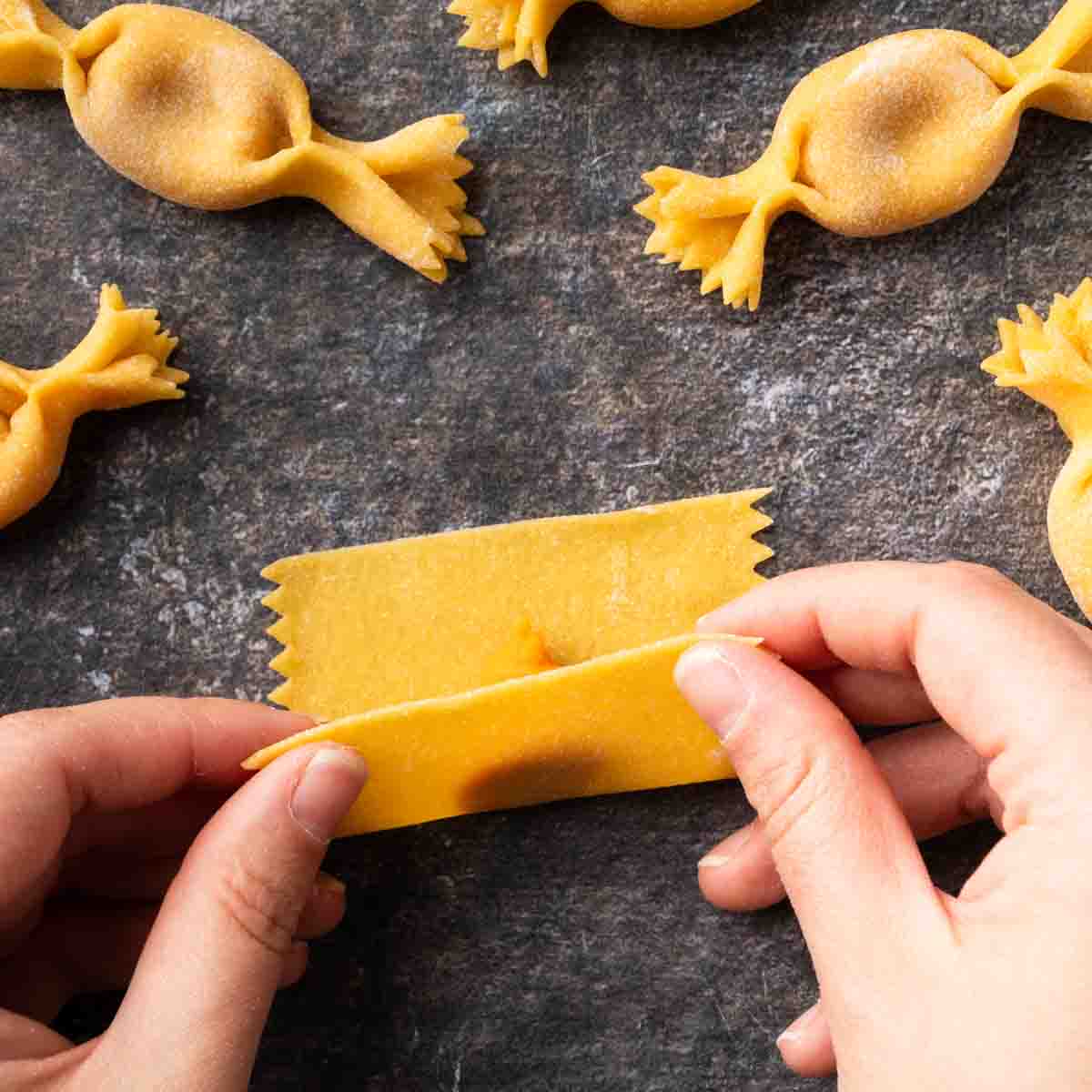 Rolling the pasta dough over the dollop of sweet potato filling.