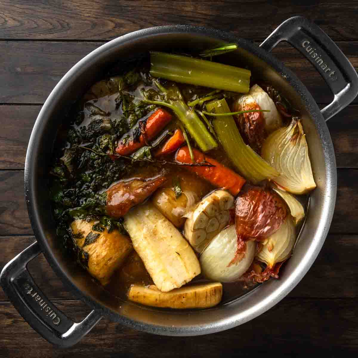 A big pot of turkey stock, herbs and aromatic vegetables.